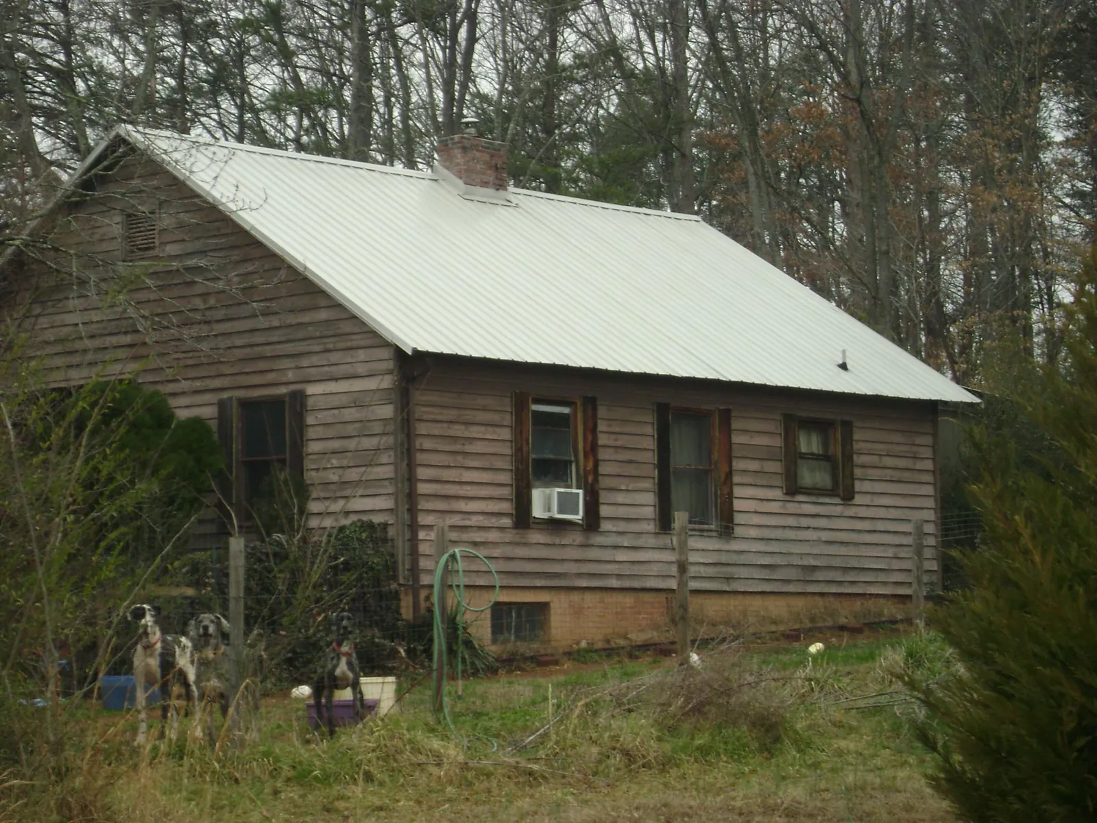 White metal roof on an old wood sided farmhouse, from a Metal Roof Installation job in West Chester